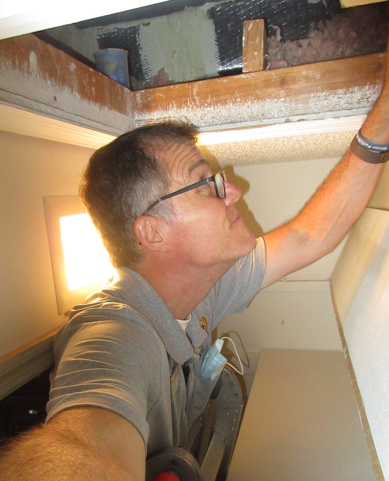 Peering into attic tight squeeze